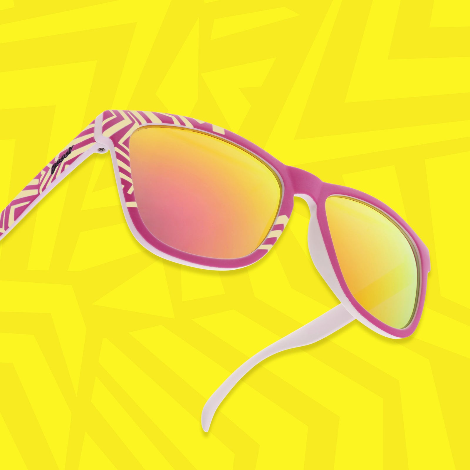 Three-quarter view of a pair of sunglasses with a bright geometric purple and yellow design floating on a yellow background with a geometric design.