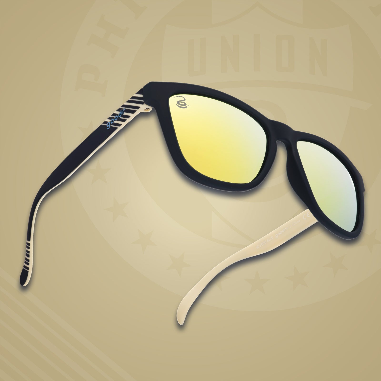 Three-quarter angle front view of MLS Philadelphia Union shades on a gold background. Navy+gold frames. Gold lenses.