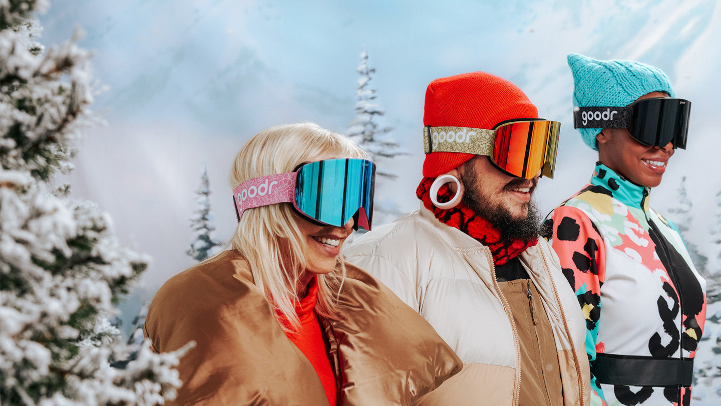 Three people skiing wearing goodr SNOW G goggles.